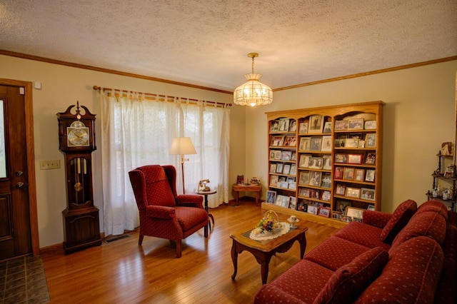 1414 Plains Rd, Leslie, MI 49251 - living area featuring a chandelier, crown molding, visible vents, a textured ceiling, and wood finished floors