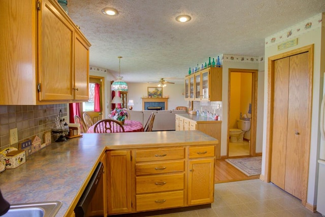 1414 Plains Rd, Leslie, MI 49251 - kitchen featuring decorative backsplash, open floor plan, dishwasher, a peninsula, and a ceiling fan