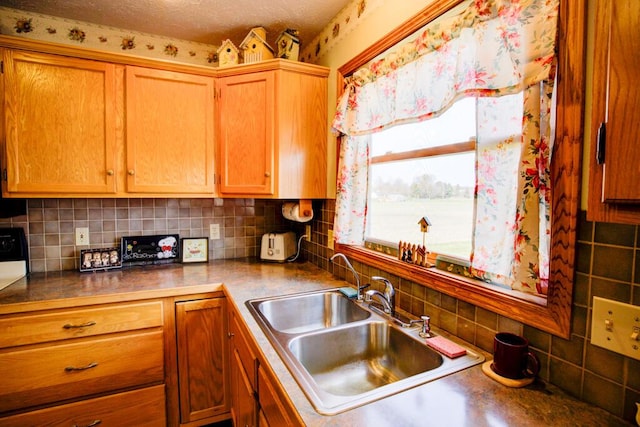 1414 Plains Rd, Leslie, MI 49251 - kitchen with tasteful backsplash, brown cabinetry, and a sink