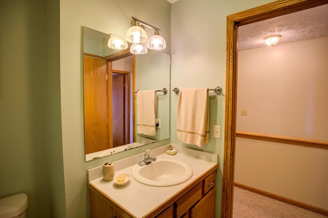 1414 Plains Rd, Leslie, MI 49251 - bathroom featuring toilet, a textured ceiling, and vanity