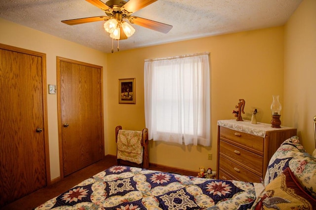 1414 Plains Rd, Leslie, MI 49251 - bedroom featuring carpet flooring, a ceiling fan, baseboards, a textured ceiling, and multiple closets