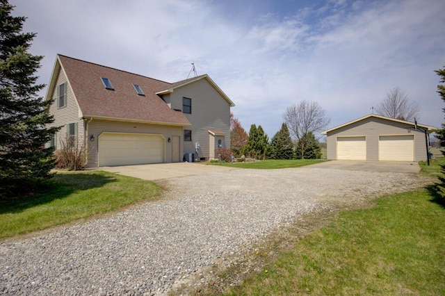 1414 Plains Rd, Leslie, MI 49251 - view of front of home featuring an outbuilding, a front yard, and a shingled roof