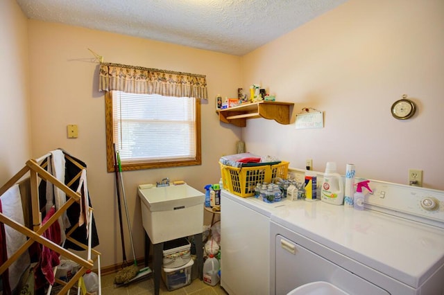 1414 Plains Rd, Leslie, MI 49251 - laundry room with a textured ceiling, a sink, laundry area, and washer and clothes dryer
