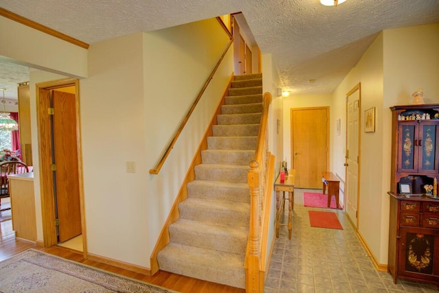 1414 Plains Rd, Leslie, MI 49251 - staircase with baseboards and a textured ceiling