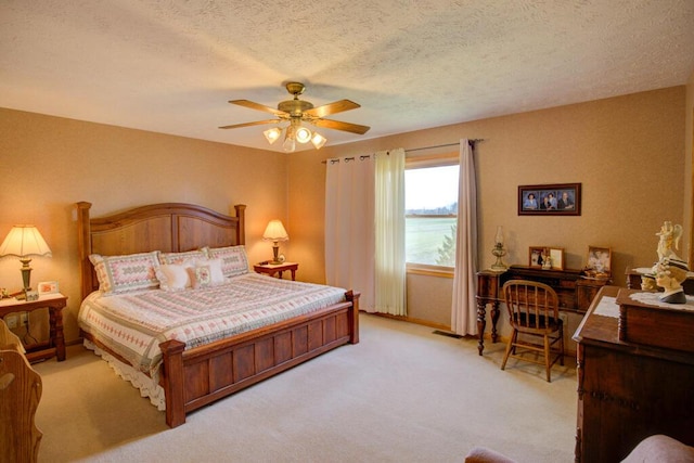1414 Plains Rd, Leslie, MI 49251 - bedroom featuring visible vents, a ceiling fan, light carpet, and a textured ceiling