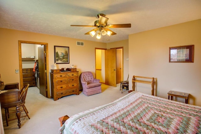 1414 Plains Rd, Leslie, MI 49251 - bedroom with a spacious closet, light colored carpet, a closet, ceiling fan, and visible vents