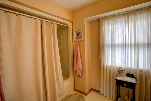 1414 Plains Rd, Leslie, MI 49251 - bathroom with baseboards and shower / bath combo with shower curtain