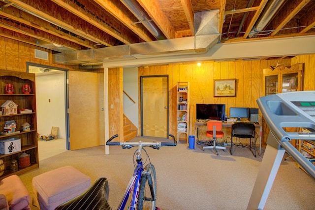 1414 Plains Rd, Leslie, MI 49251 - workout room featuring visible vents, wooden walls, and carpet