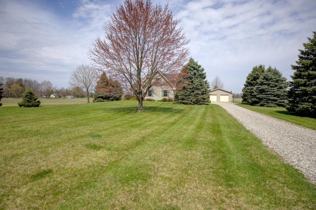 1414 Plains Rd, Leslie, MI 49251 - view of front of house featuring an outbuilding, a front lawn, and a detached garage