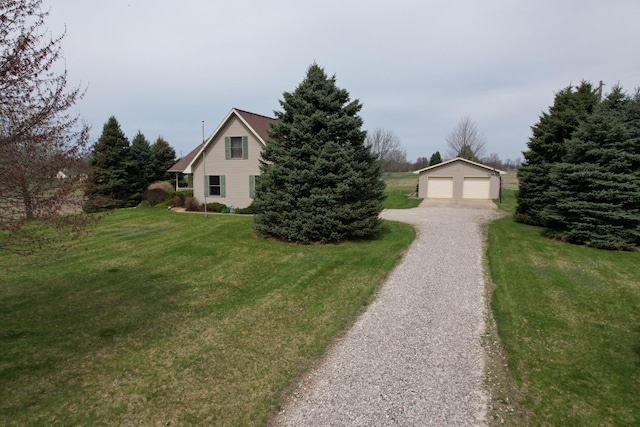 1414 Plains Rd, Leslie, MI 49251 - view of front of house featuring a garage, an outdoor structure, and a front lawn