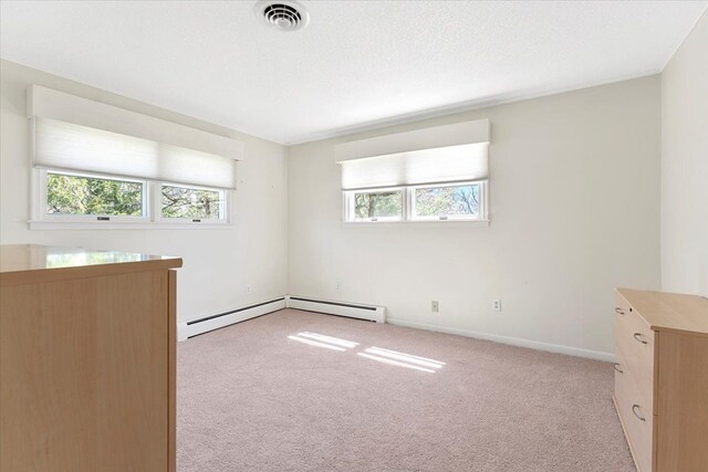 unfurnished room with baseboards, light carpet, and visible vents