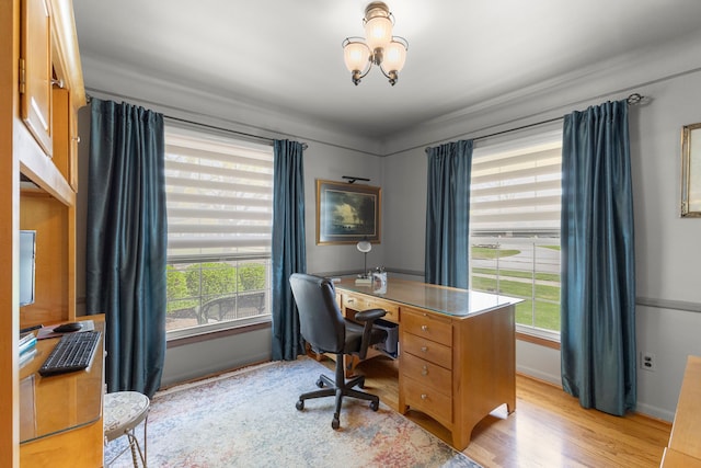 office area featuring a chandelier, light wood-type flooring, and baseboards