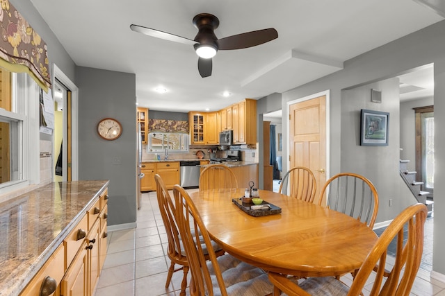 dining room featuring stairway, light tile patterned floors, a ceiling fan, visible vents, and baseboards