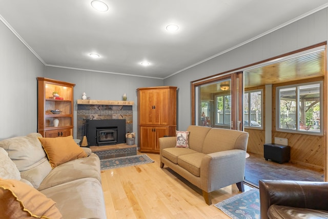 living area with wood walls, light wood-type flooring, recessed lighting, and crown molding