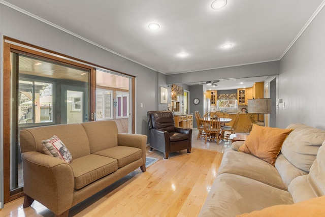living area featuring recessed lighting, light wood-style flooring, and crown molding
