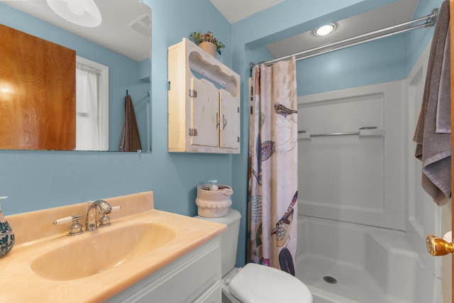 bathroom with a shower with shower curtain, toilet, and vanity