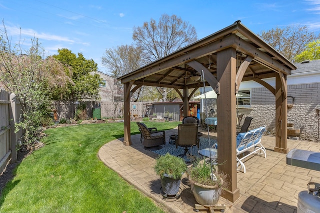 view of patio / terrace with a gazebo, a fenced backyard, and a ceiling fan