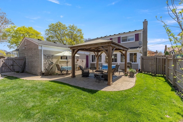 back of house with a gazebo, a gate, an outdoor living space, and a fenced backyard