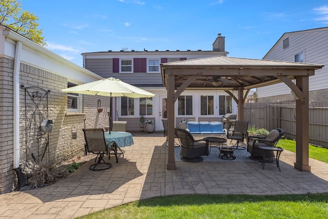 view of patio / terrace featuring an outdoor living space, a gazebo, and fence