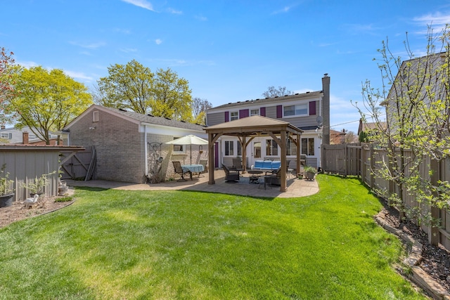 back of house featuring a patio area, a yard, a fenced backyard, outdoor lounge area, and a gazebo