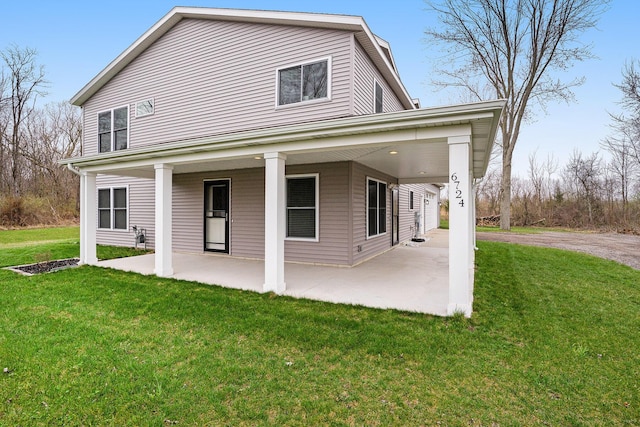 back of house featuring a lawn and a patio
