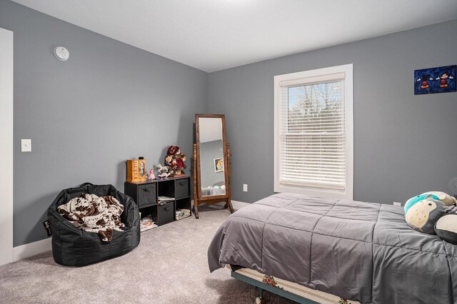 bedroom featuring carpet flooring and baseboards