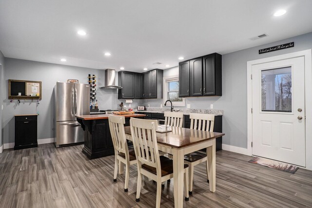 dining space with wood finished floors, visible vents, recessed lighting, and baseboards