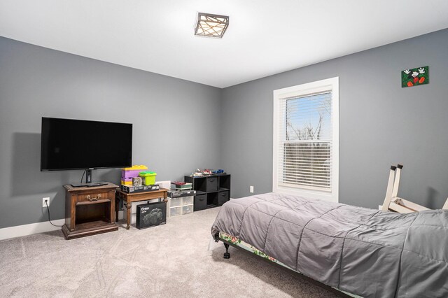 bedroom featuring carpet floors and baseboards