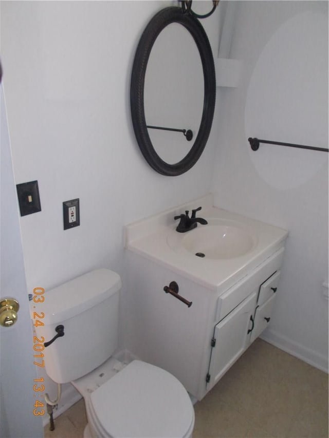 bathroom featuring toilet and vanity