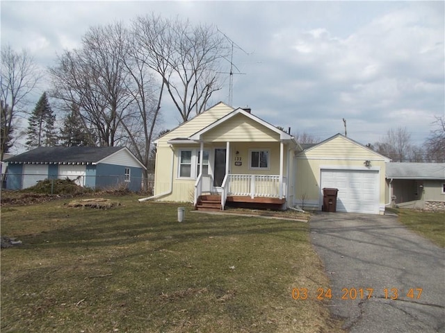 view of front of property with a porch, a garage, and asphalt driveway