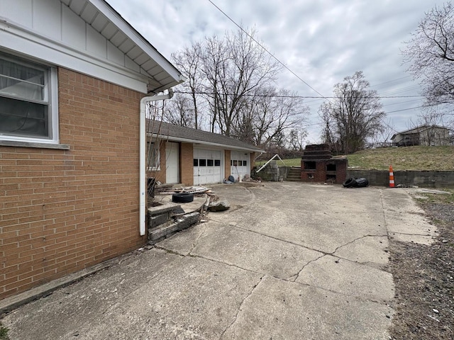 view of patio / terrace featuring driveway and an attached garage