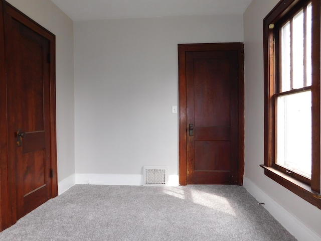 carpeted empty room with visible vents
