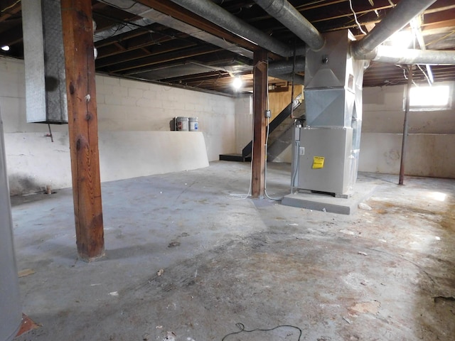basement featuring heating unit and stairs