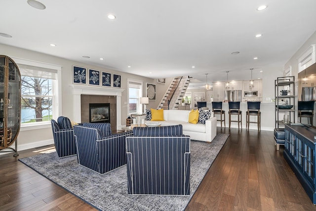 1300 N Eagle Lake Dr, Kalamazoo, MI 49009 - living room featuring baseboards, recessed lighting, a tile fireplace, dark wood-style floors, and stairway