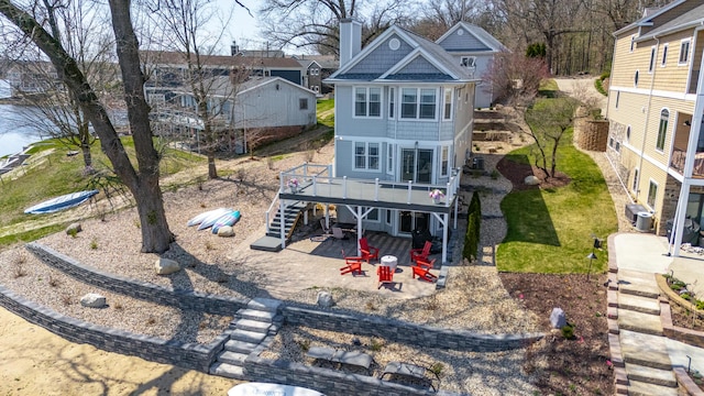 1300 N Eagle Lake Dr, Kalamazoo, MI 49009 - rear view of property with a patio, a wooden deck, a chimney, stairway, and central AC unit