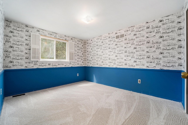 unfurnished room featuring visible vents, wallpapered walls, and carpet floors