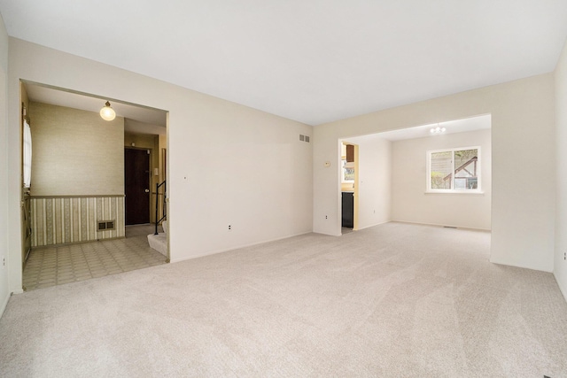 unfurnished room featuring visible vents and carpet floors