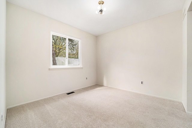 unfurnished room featuring baseboards, visible vents, and carpet floors