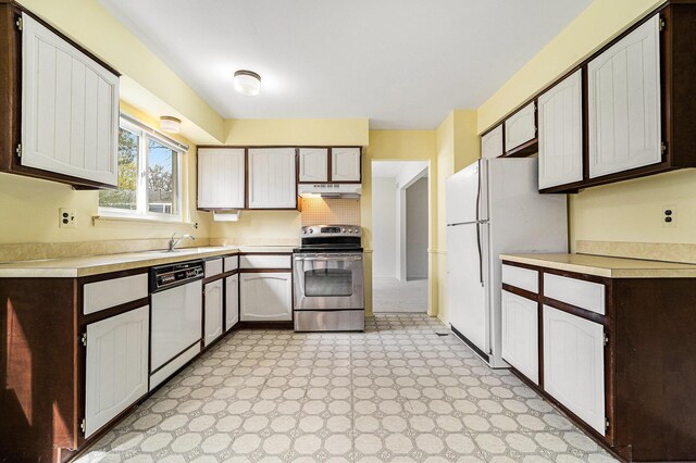 kitchen featuring light floors, white appliances, under cabinet range hood, and light countertops