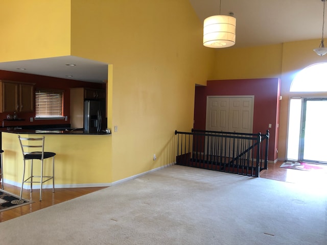 1130 Andover Cir, Commerce Twp, MI 48390 - carpeted entryway featuring a towering ceiling, healthy amount of natural light, and baseboards