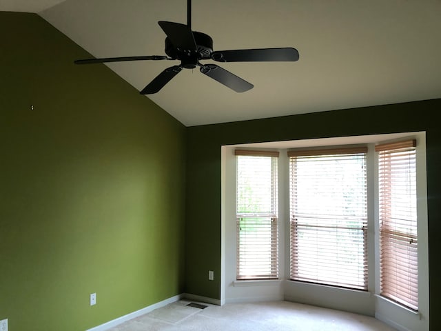 1130 Andover Cir, Commerce Twp, MI 48390 - spare room with lofted ceiling, light colored carpet, ceiling fan, baseboards, and plenty of natural light