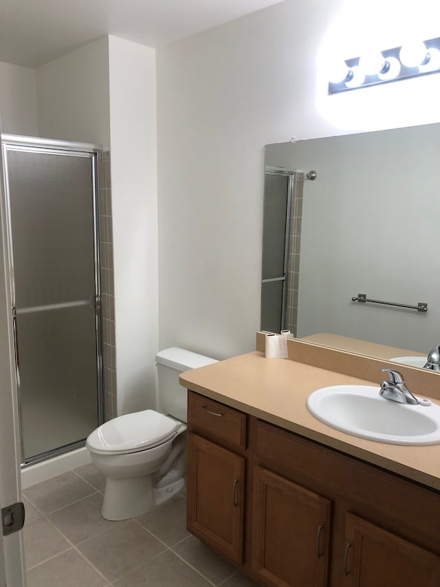 1130 Andover Cir, Commerce Twp, MI 48390 - bathroom featuring tile patterned floors, a shower stall, toilet, and vanity