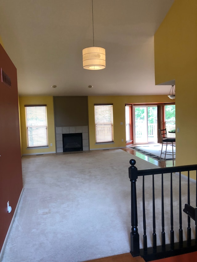 1130 Andover Cir, Commerce Twp, MI 48390 - unfurnished living room with plenty of natural light, carpet flooring, and a fireplace