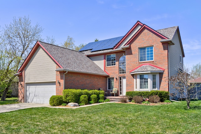 traditional home with brick siding, roof mounted solar panels, driveway, and a front yard