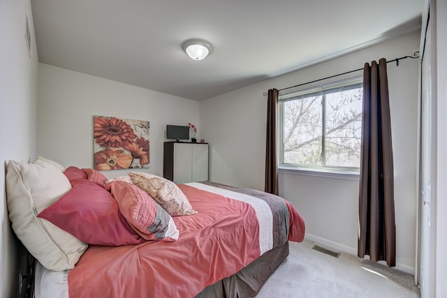 bedroom with baseboards, carpet flooring, and visible vents