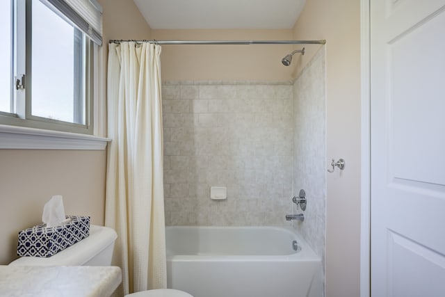 bathroom with shower / tub combo with curtain and toilet
