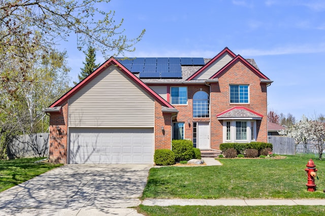 traditional-style home featuring fence, a front lawn, brick siding, roof mounted solar panels, and concrete driveway