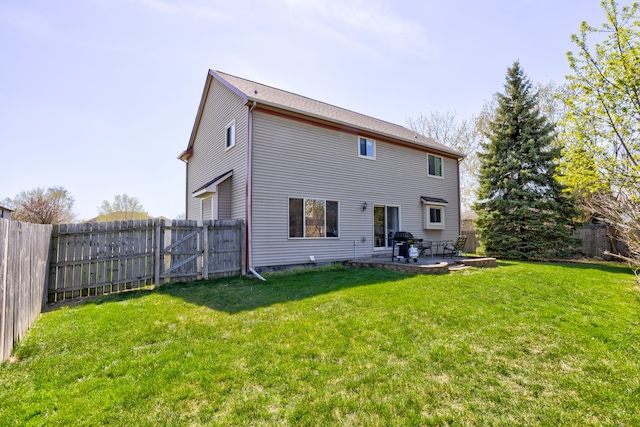 back of house with a fenced backyard, a gate, a lawn, and a patio area