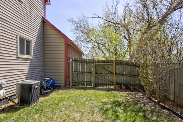 view of yard featuring central air condition unit, a gate, and a fenced backyard