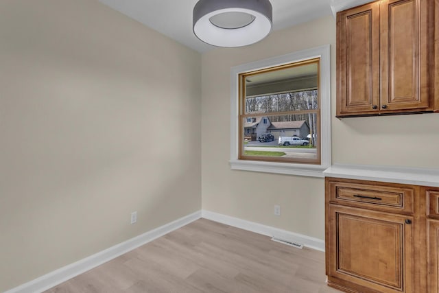 9315 Kingsley Dr, Onsted, MI 49265 - unfurnished dining area featuring visible vents, baseboards, and light wood-style floors